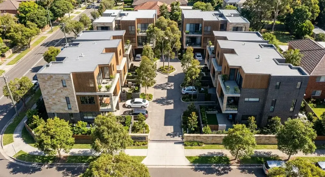 Aerial photograph of a completed medium-density townhouse development, illustrating a site's full development potential