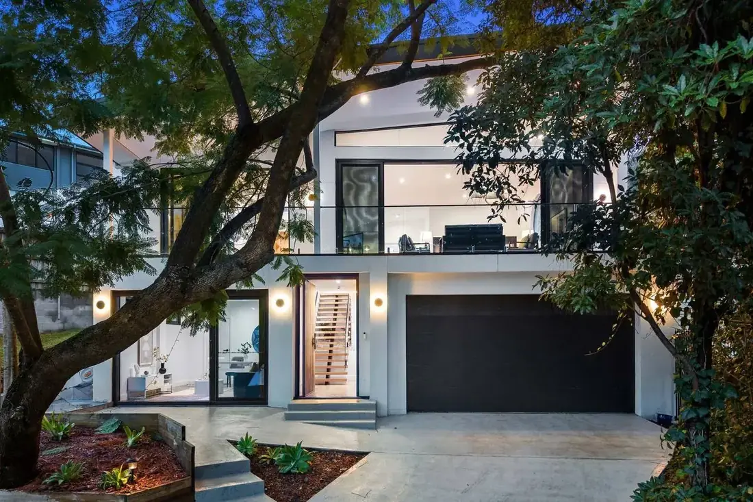 Modern residential transformation designed around an existing mature tree