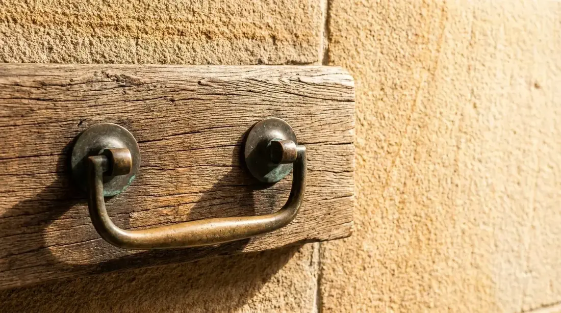 Sandstone and aged timber material detail from the Harbour Hillside Residence material palette