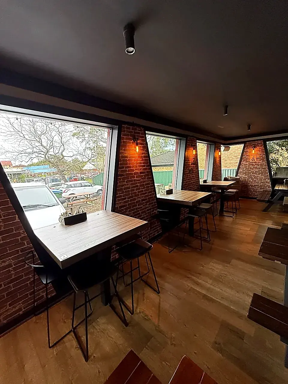 Raked brick piers and angled windows with bar seating in the completed Smoke Shaq fit-out at Mt Colah
